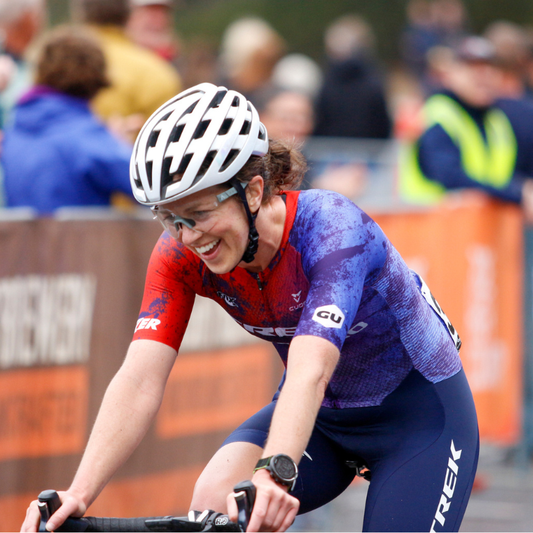 Smiling rider crosses finish line of Tour of Bright